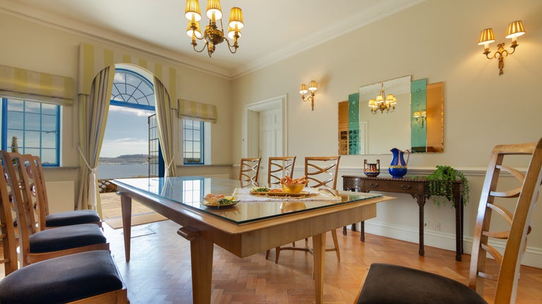 The dining room on the ground floor of Portland House, with patio doors onto the terrace, Dorset